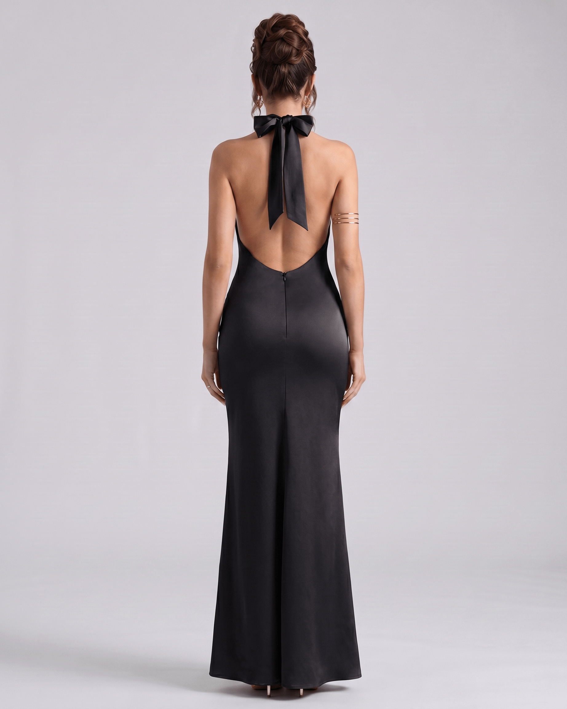 Zerelle Maxi Dress in black, featuring a smooth polyester fabric, halter neckline, and elegant ruffle details by Lauven.