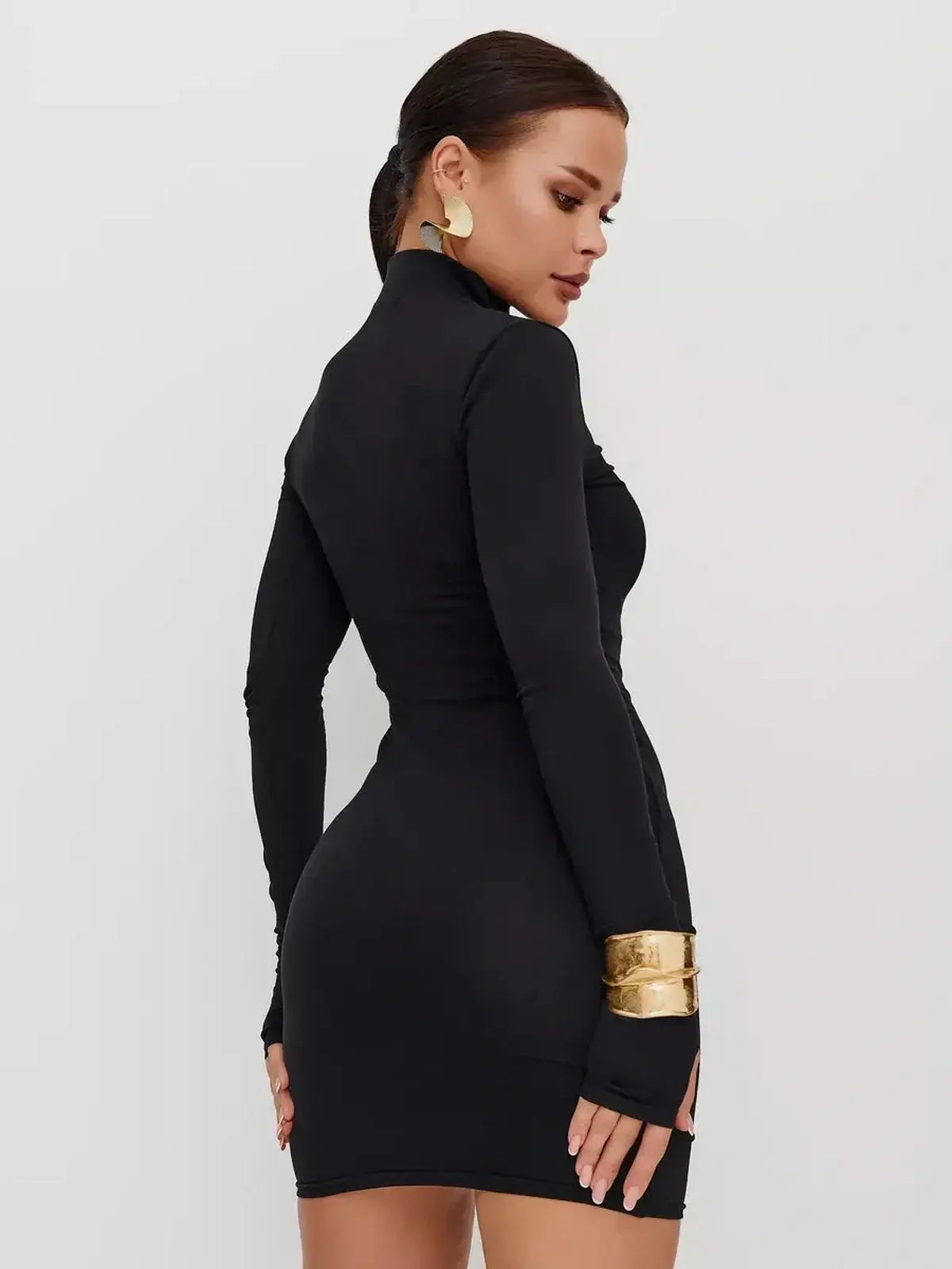 Model showcasing the sleek black Zip Form Mini Dress with long sleeves and a high collar, perfect for cocktail events.