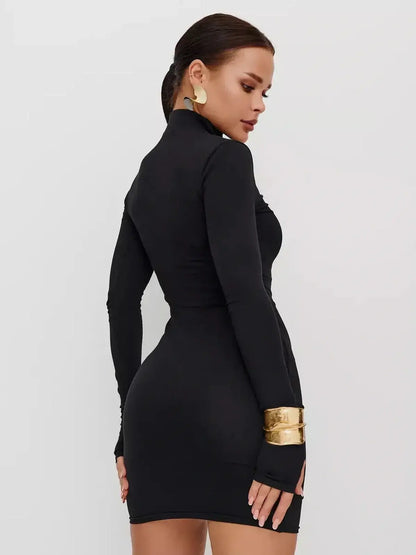 Model showcasing the sleek black Zip Form Mini Dress with long sleeves and a high collar, perfect for cocktail events.